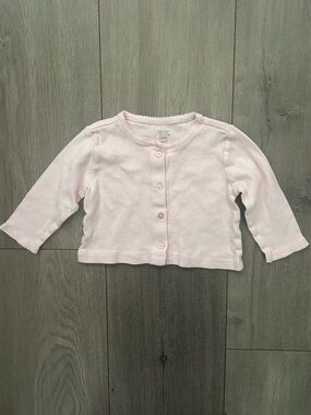 Light pink baby cardigan featuring a button-down front: 6 months